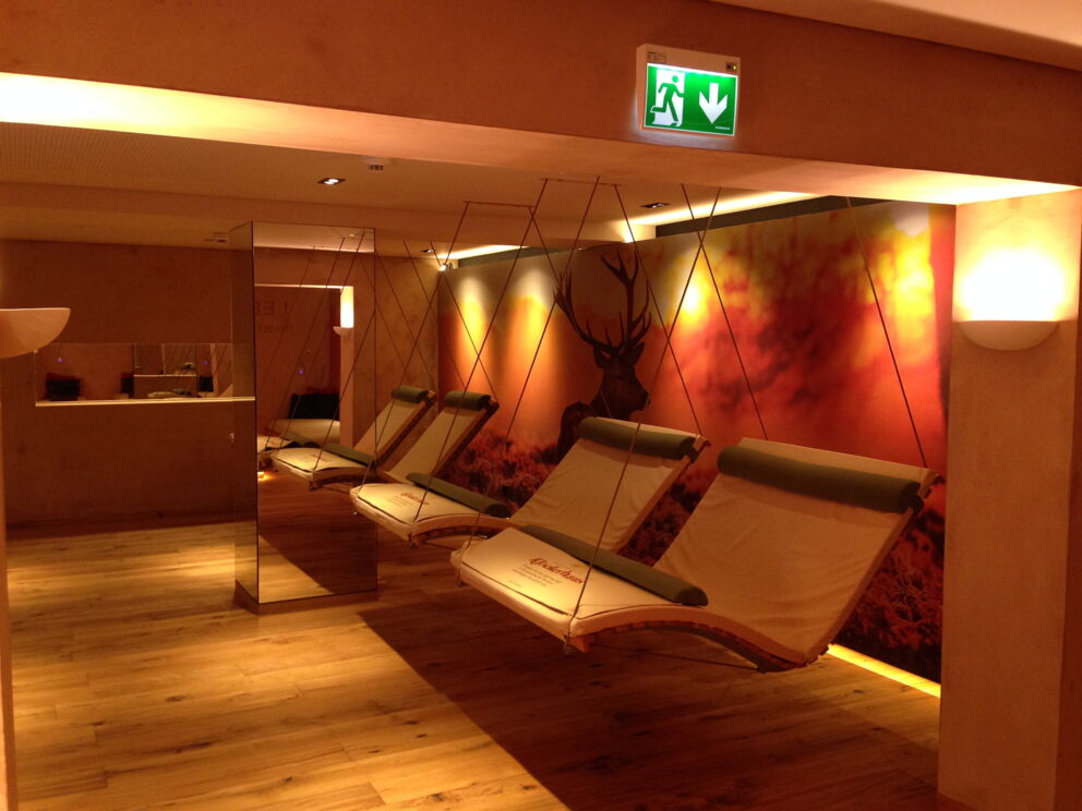 Comfortable loungers in a warm, atmospheric room with a forest theme
