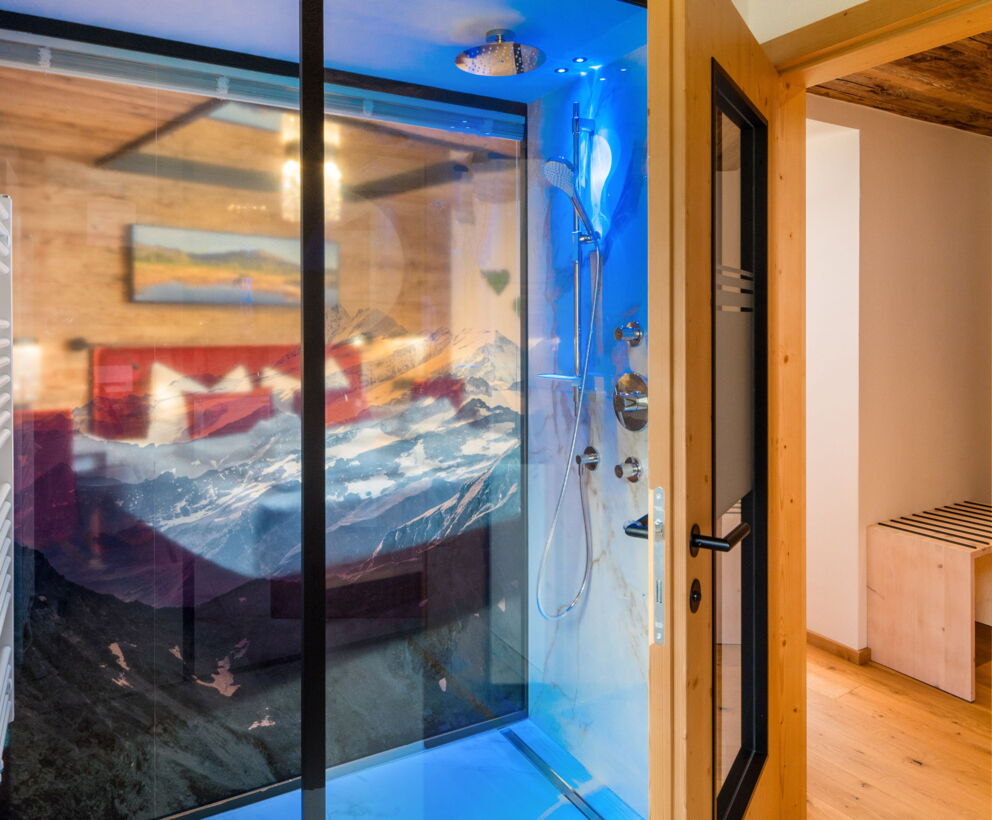 Schlafzimmer des Kuschelzimmers mit rotem Doppelbett und moderner Holzverkleidung