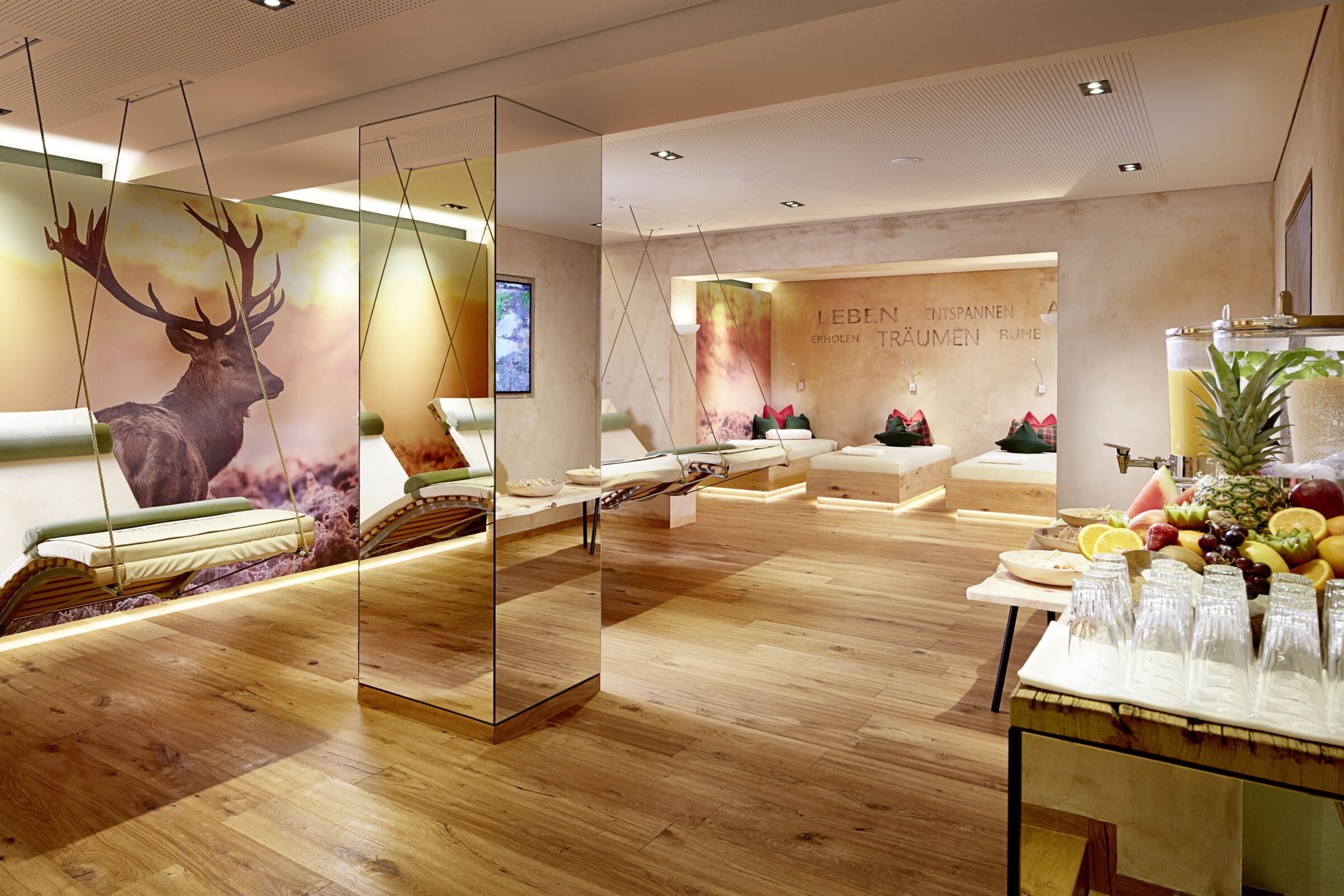 Gemütliche Lounge mit Schaukelstühlen, Obstbuffet und beruhigender Hirschdekor-Wand.